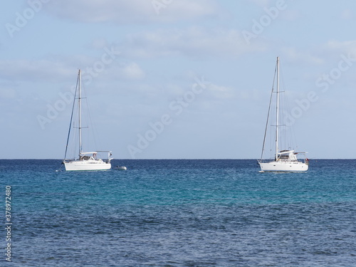Two white yachts on waters of Atlantic Ocean at Sal island, Cape Verde