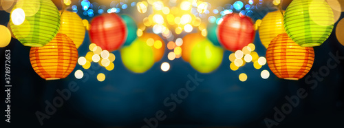 Festive background with colorful lights garland and bright bokeh. Holiday light decor. Celebration concept.