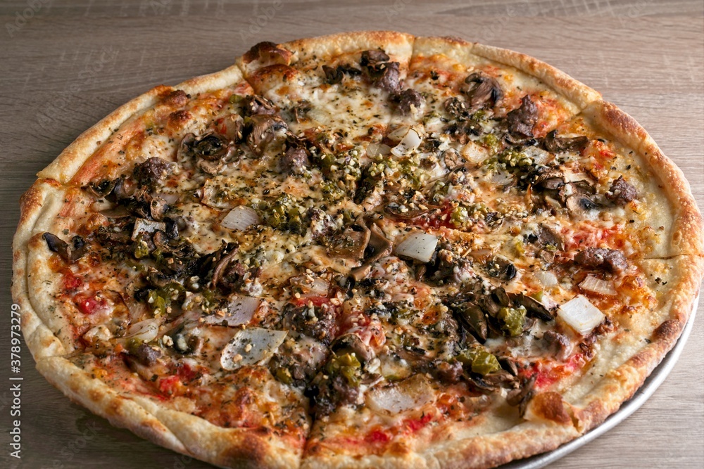 Gourmet pizza with sausage, onion, jalapeño & black olive