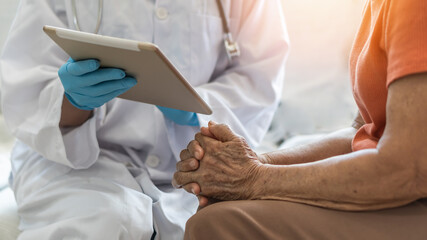 Elderly senior adult patient (older person) having geriatric doctor consulting and diagnostic examining on aging and mental health care in medical clinic office or hospital examination room