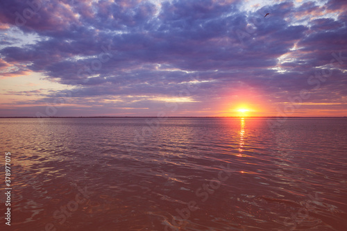 Colorful cloudy sky at sunset. Sunset over the sea. Gradient color. Sky texture. Abstract nature background