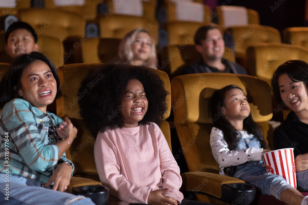 Happy family watching movie in cinema theatre. Happy family time in holiday