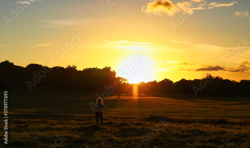 Sunset mood, silhouette girl, and nature scenery.