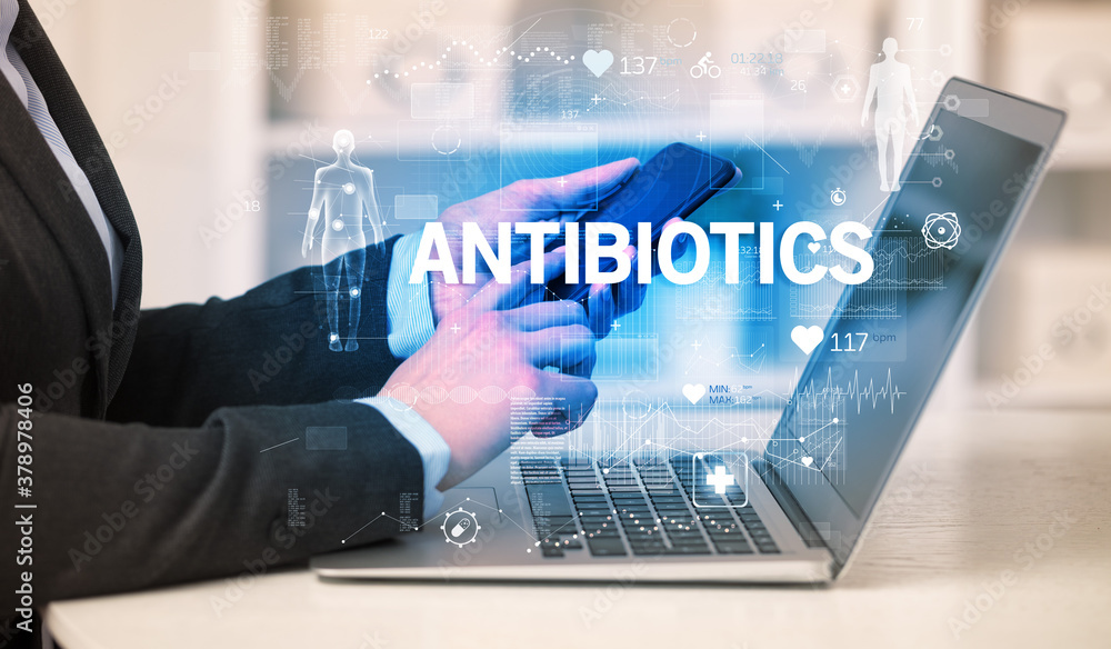 Doctor working a health check with ANTIBIOTICS inscription, recording medical test results Doctor working a health check with ANTIBIOTICS inscription, recording medical test results