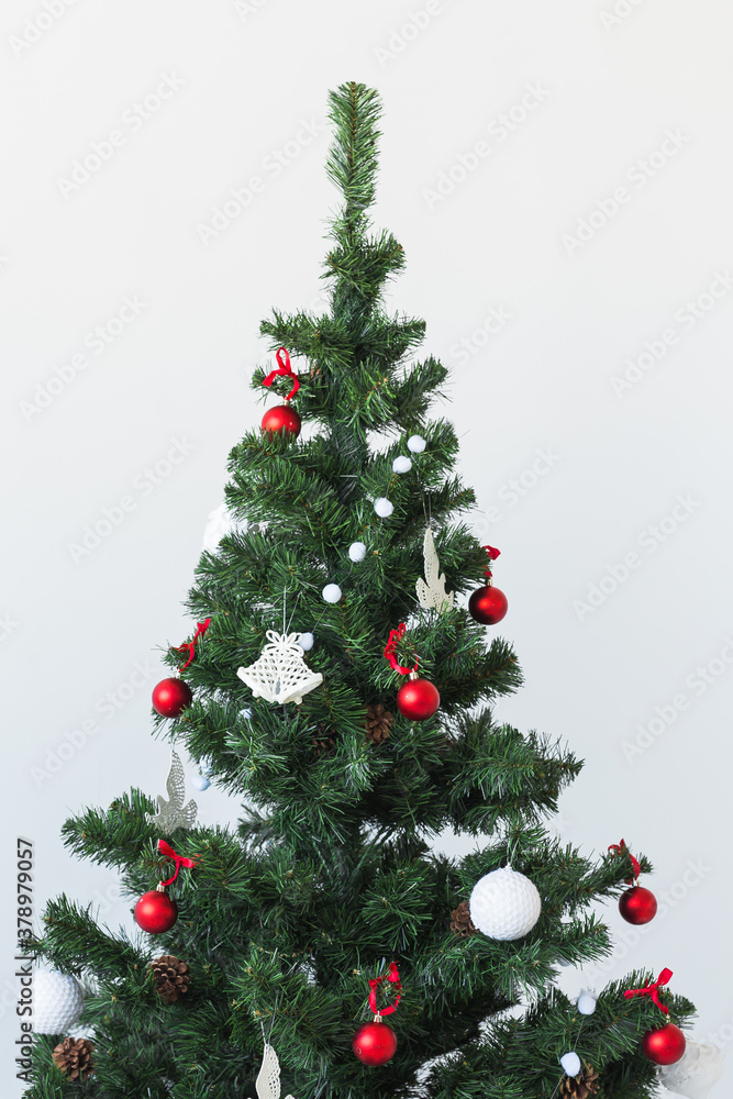 Holidays and celebration concept - Decorated Christmas tree on white background with copy space.