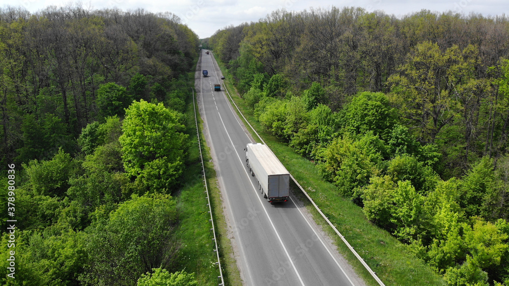 Aerial. Truck motion by the highway. View above from drone.