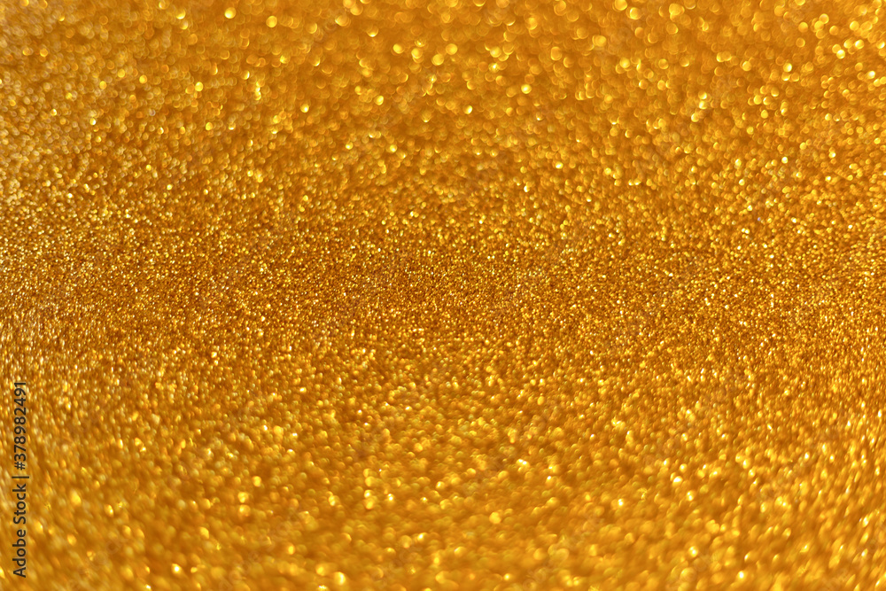Golden abstract defocused bokeh background. Sparkling texture