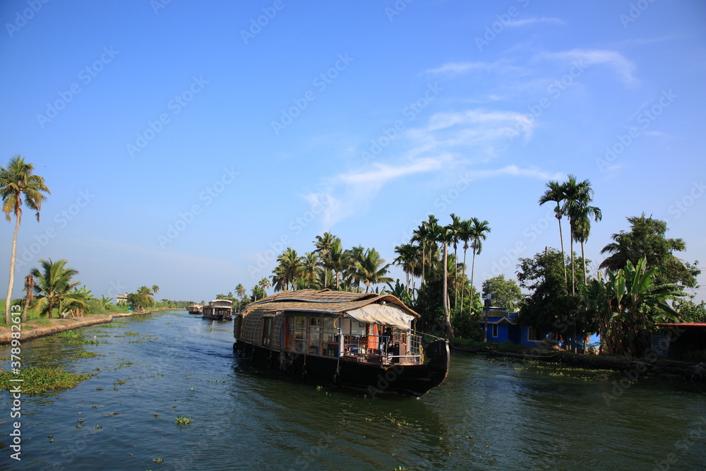 Scenic view of Houseboat sailing on Kerala backwaters in Alleppey, Kerala, India Scenic view of Houseboat sailing on Kerala backwaters in Alleppey, Kerala, India