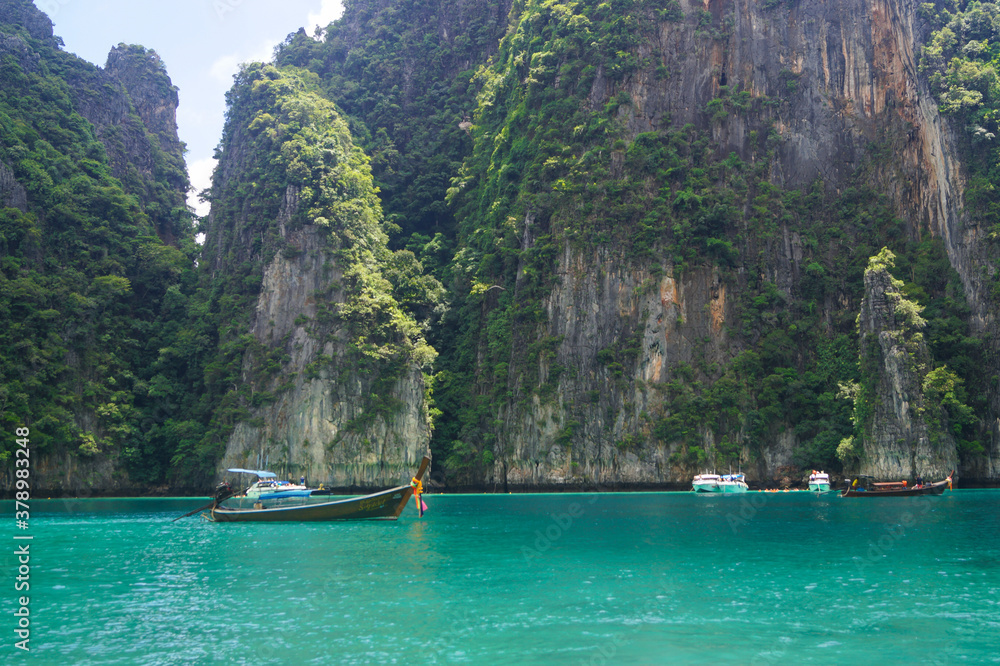 Stunning tropical rocks with palm trees in the Bay on Phi Phi island in Thailand. Landscape Stunning tropical rocks with palm trees in the Bay on Phi Phi island in Thailand. Landscape