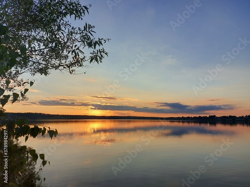 Orange sunset over a large lake in the Moscow region. High quality photo