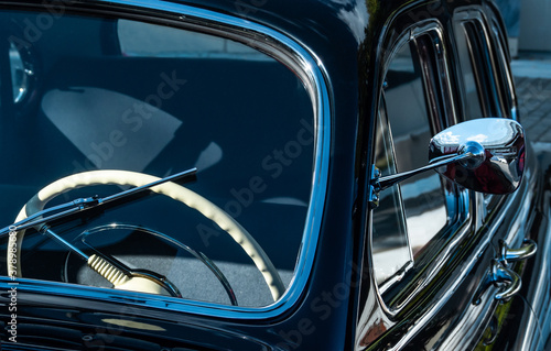 Retro car show. Black classic retro car. Vintage car fragment. Black GAZ 12 ZIM at the at the retro car show © Evgesha