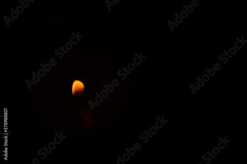 a candle lit in the dark