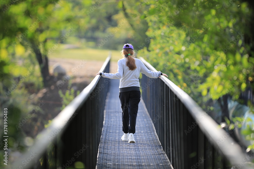 young girl walking on the bridge