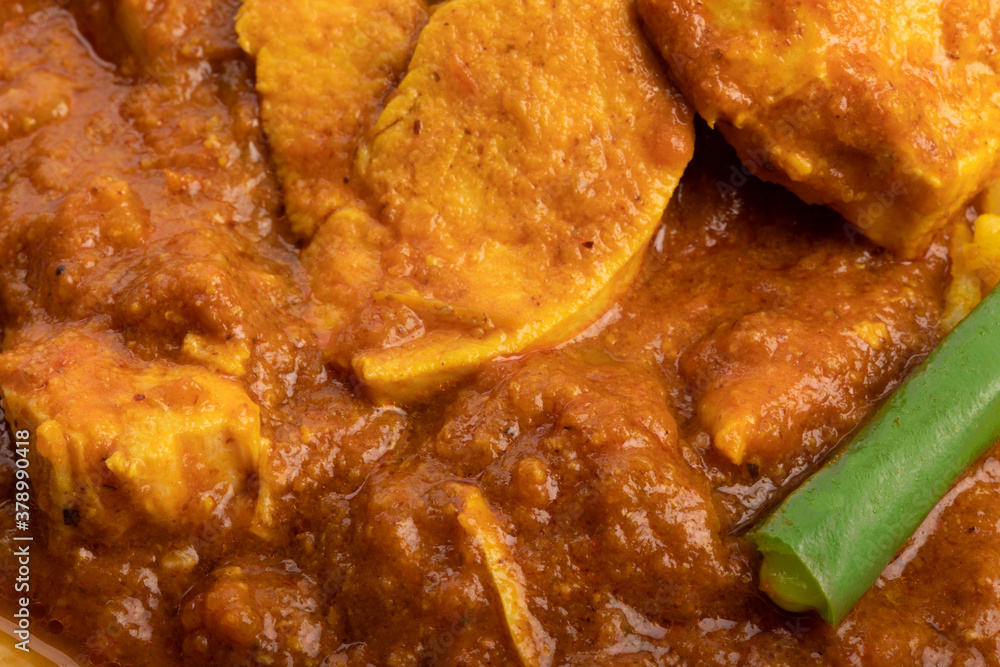 extreme closeup of Indian buttered chicken and green beans extreme closeup of Indian buttered chicken and green beans