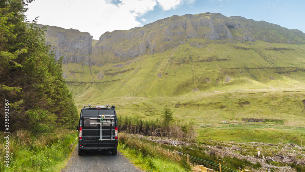 Black campingcar driving in the valley of Gleniff Horseshoe Drive in Ireland