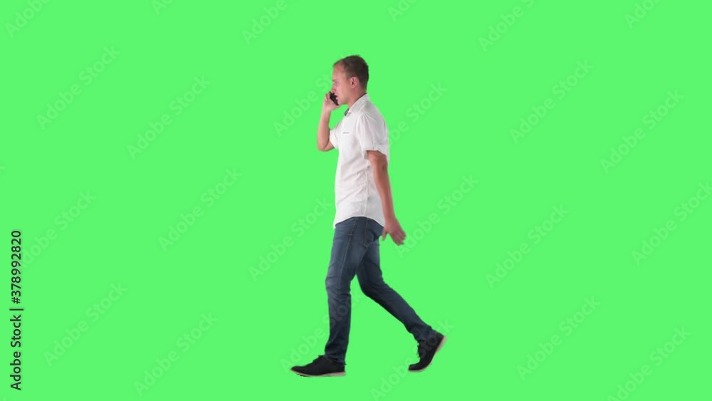 Rushing busy serious business man walking and talks on the phone. Full body on green screen chroma key background. Rushing busy serious business man walking and talks on the phone. Full body on green screen chroma key background.