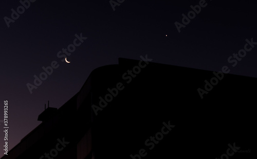 Crescent moon over the city 