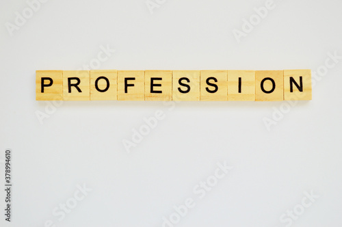 Word profession. Wooden blocks with lettering on top of white background. Top view of wooden blocks with letters on white surface