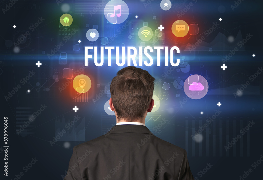 Rear view of a businessman with FUTURISTIC inscription, modern technology concept Rear view of a businessman with FUTURISTIC inscription, modern technology concept