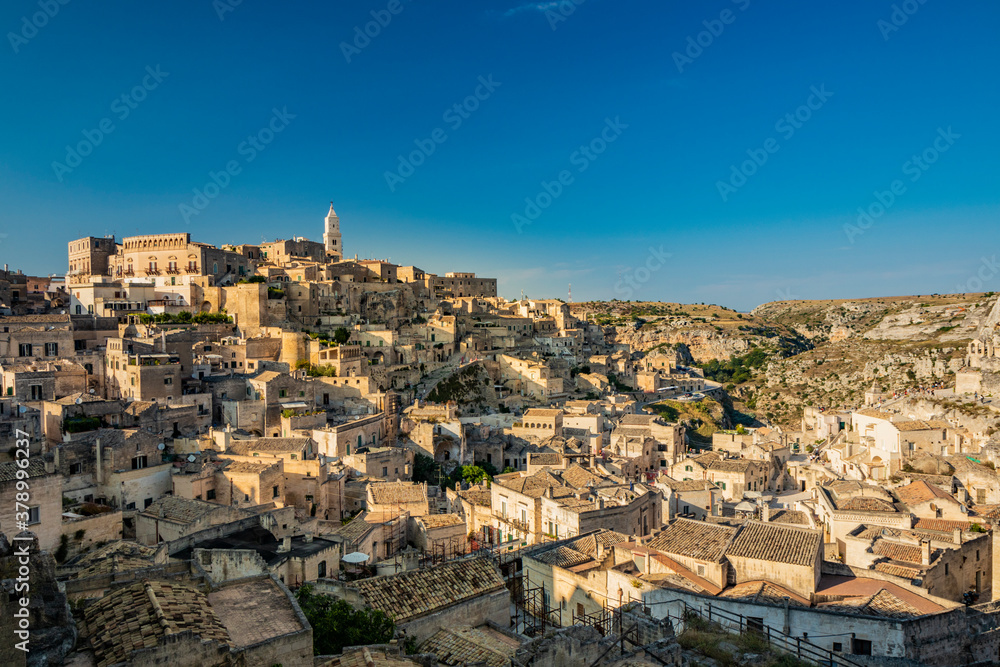 Matera, Basilicata, Italy - Panoramic view from the top of the Sassi of Matera, Barisano and Caveoso. The ancient houses of stone and brick, carved into the rock. The ravine in the background.