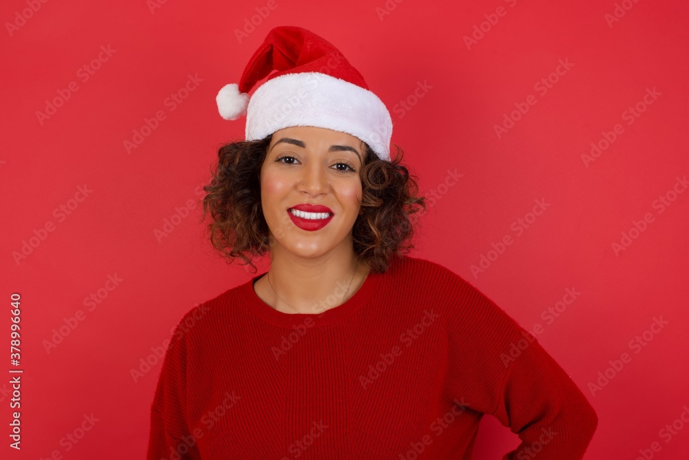 Studio shot of cheerful businesswoman keeps hand on hip, smiles broadly, anticipates for surprise prepared by friends on her birthday, isolated over background. Studio shot of cheerful businesswoman keeps hand on hip, smiles broadly, anticipates for surprise prepared by friends on her birthday, isolated over background.
