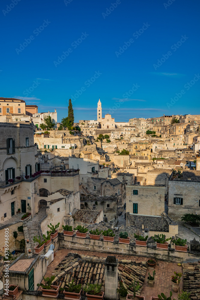 Matera, Basilicata, Italy - Panoramic view of the Sassi of Matera, Caveoso. The ancient houses of stone and brick, carved into the rock. The cathedral in the background.