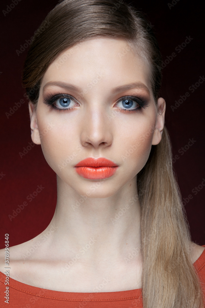 Frontal portrait of cute young woman with bright natural makeup, oranges lips and hair tight in the tail. Pretty girl with beautiful eyes, looking at camera. Frontal portrait of cute young woman with bright natural makeup, oranges lips and hair tight in the tail. Pretty girl with beautiful eyes, looking at camera.