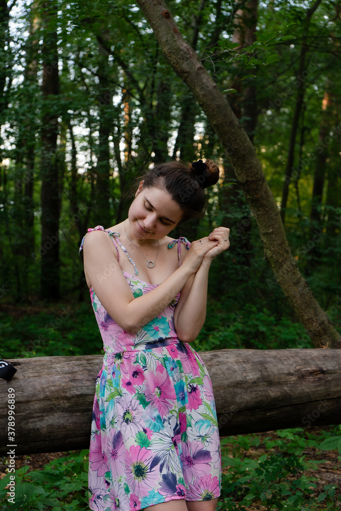 Young women in dress posing in the forest Young women in dress posing in the forest