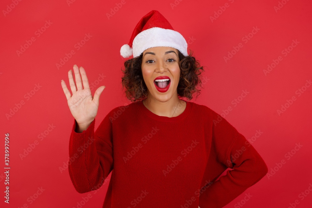 Young beautiful woman standing over yellow isolated background Waiving saying hello or goodbye happy and smiling, friendly welcome gesture