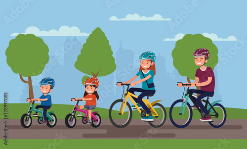 Active family vacation. Father mother, son and daughter are riding on bicycles in the park.