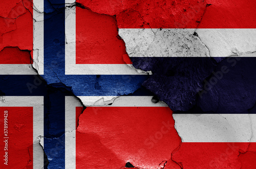 flags of Norway and Thailand painted on cracked wall