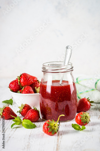 Strawberry jam in the glass jar.