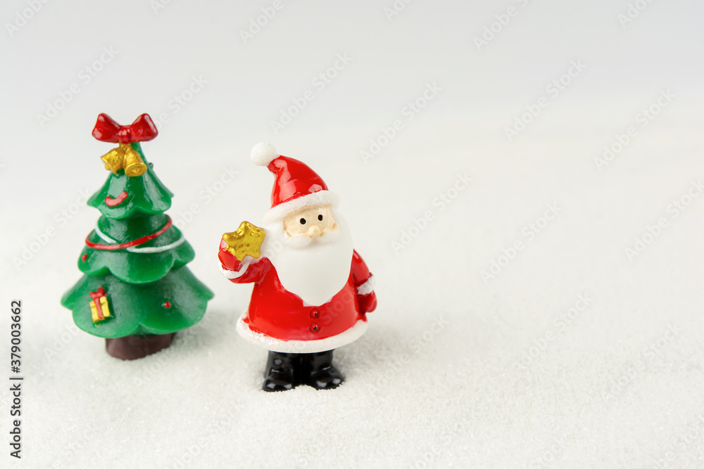 Merry Christmas and happy new year concept. Cute santa claus figure and tree on snow with copy space Merry Christmas and happy new year concept. Cute santa claus figure and tree on snow with copy space