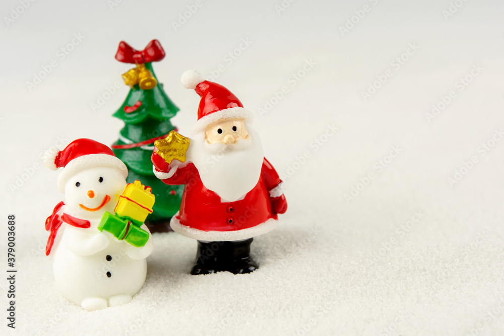 Merry Christmas and happy new year concept. Cute santa claus figure and tree on snow with copy space Merry Christmas and happy new year concept. Cute santa claus figure and tree on snow with copy space