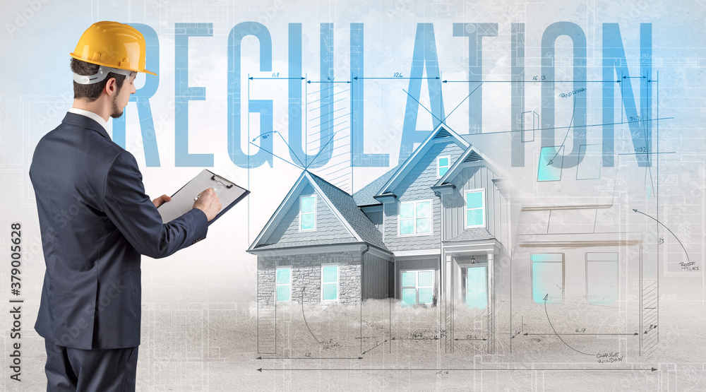 Young engineer holding blueprint with REGULATION inscription, house planning concept Young engineer holding blueprint with REGULATION inscription, house planning concept