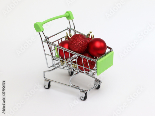 The red Christmas balls are in a shopping cart. Christmas time. Close up.