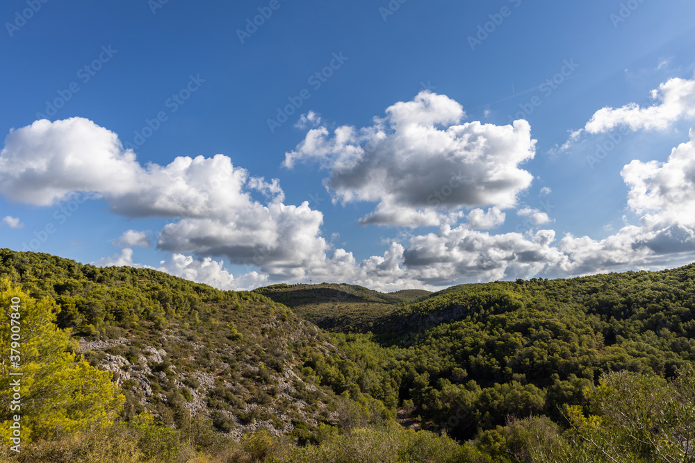 Park natural Garraf, green mountains with blue sky and clouds, Mas alba, Sitges, Spain