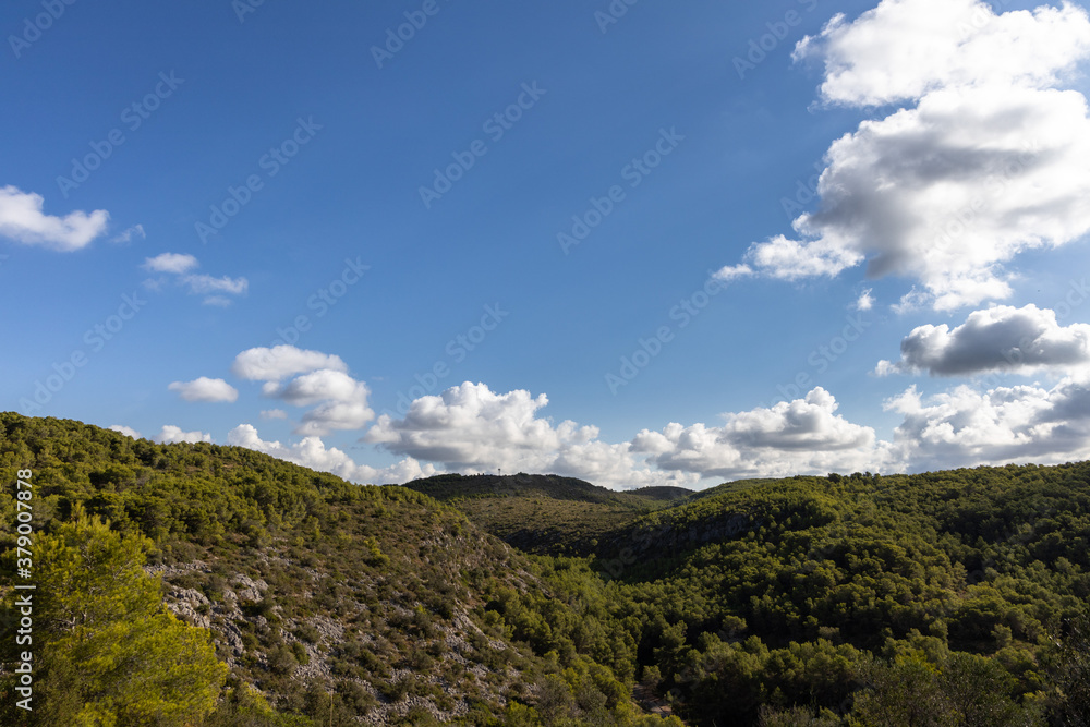 Park natural Garraf, green mountains with blue sky and clouds, Mas alba, Sitges, Spain