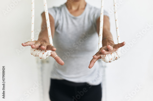 Photos Closeup hands holding the rope, iyengar yoga at studio, white wall