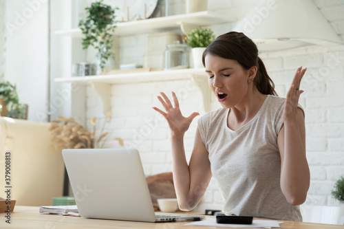 Stressful job and computer issues. Woman annoyed with slow Wi-Fi working on laptop. Angry user having trouble with laptop software. Irritated worker sick and tired of making changes in her work