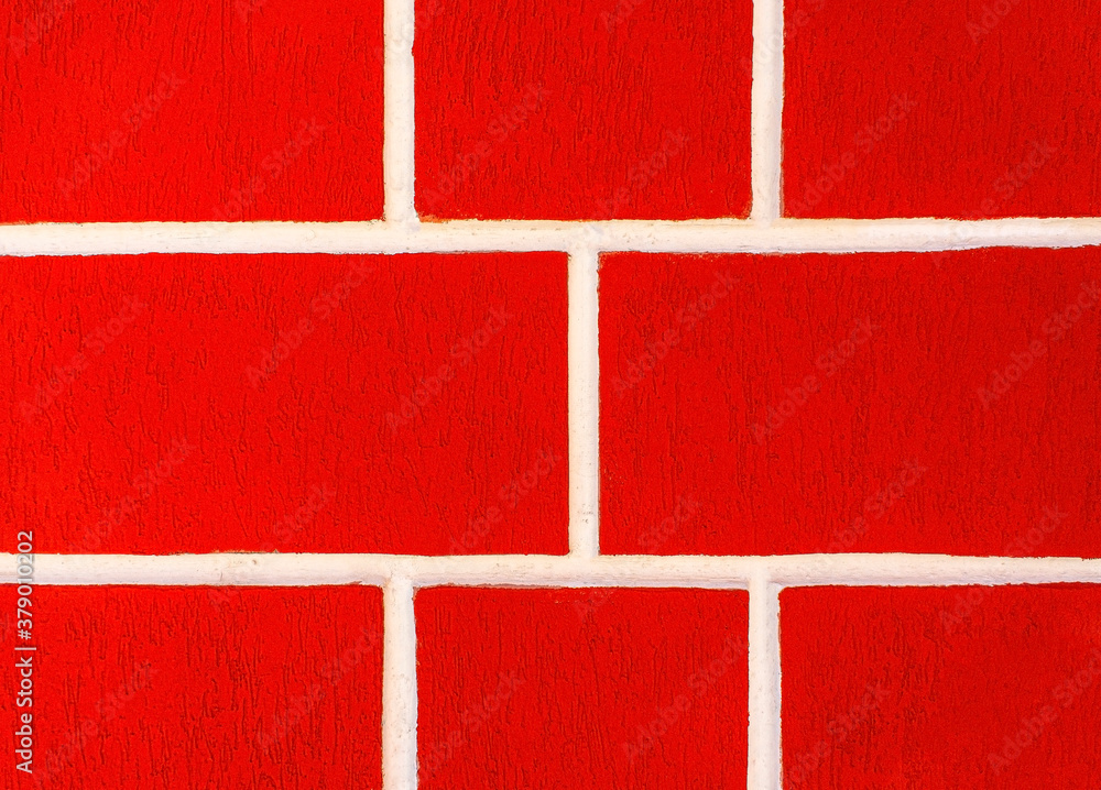 Fototapeta premium Bright red background with white seams. Wall surface. Building block wall. Copy space