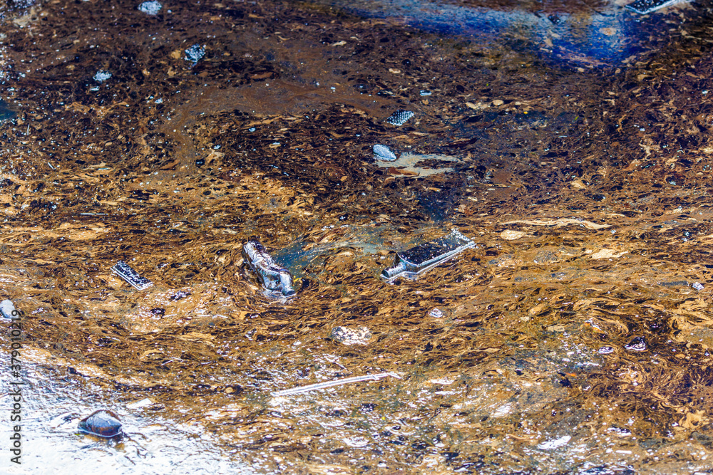 Ecological catastrophy. Close-up. Spill of oil products into the sea. Poisonous oil products float on the surface of the clean sea. Ecological catastrophy. Close-up. Spill of oil products into the sea. Poisonous oil products float on the surface of the clean sea.