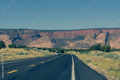 Road through Arizona landscape with large mesa