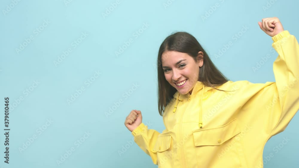 Young cute woman raising fist after a victory, winner concept Young cute woman raising fist after a victory, winner concept