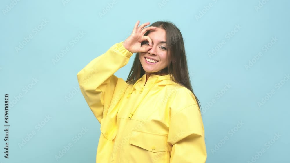 Young cute woman excited keeping ok gesture on eye Young cute woman excited keeping ok gesture on eye