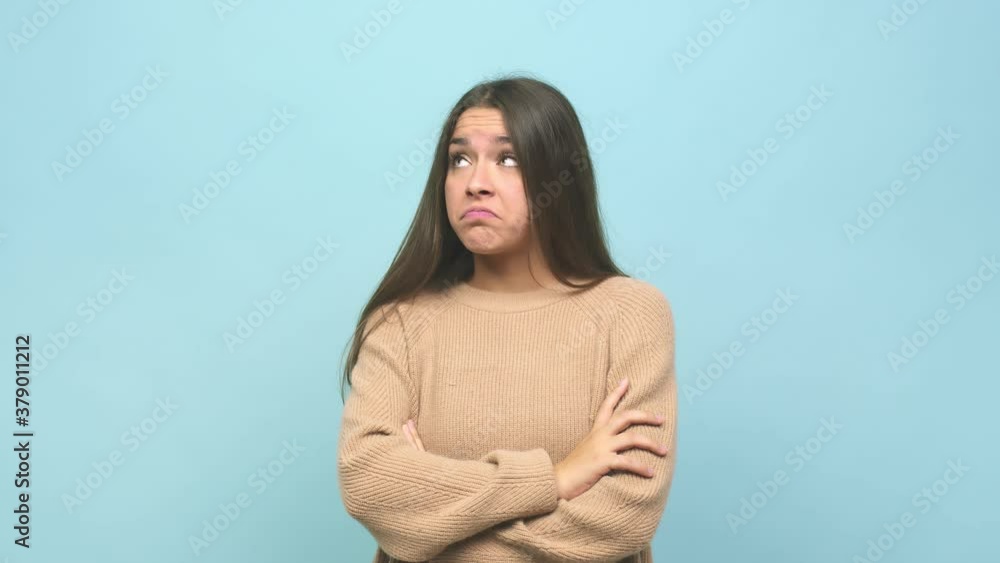 Young cute woman unhappy looking in camera with sarcastic expression Young cute woman unhappy looking in camera with sarcastic expression