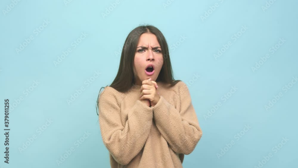 Young cute woman praying for luck, amazed and opening mouth looking to front Young cute woman praying for luck, amazed and opening mouth looking to front