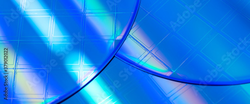 Macro of blue silicon wafer with microchips. Banner format.