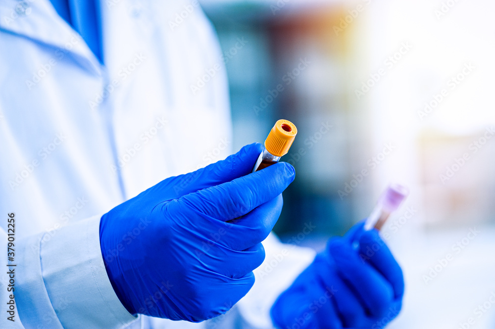 Hands in rubber gloves hold test tubes. Hands in rubber gloves hold test tubes.