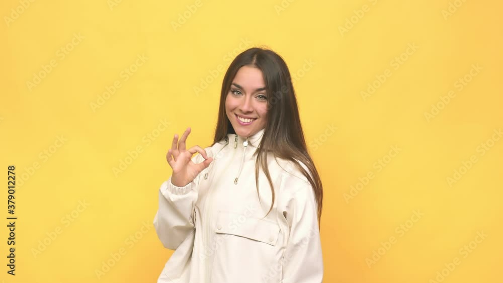 Young cute woman cheerful and confident showing ok gesture Young cute woman cheerful and confident showing ok gesture